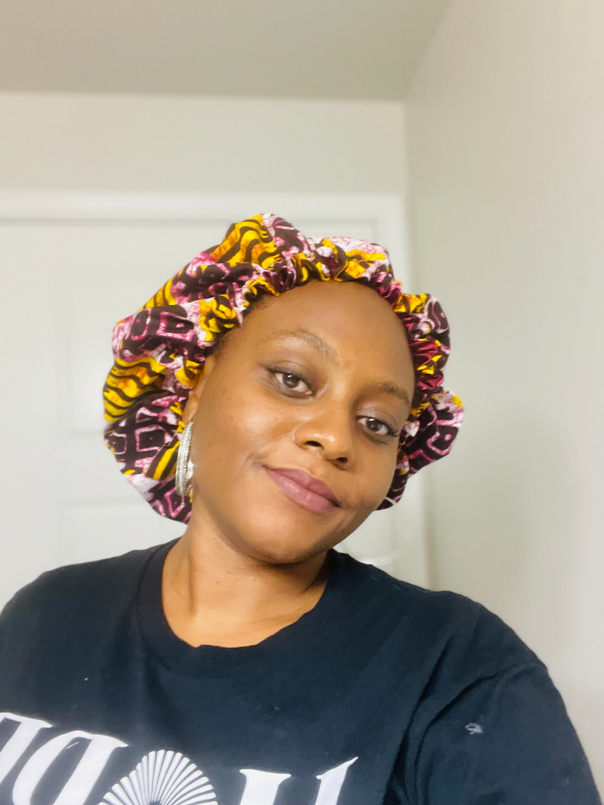 Person wearing a colorful patterned bonnet indoors