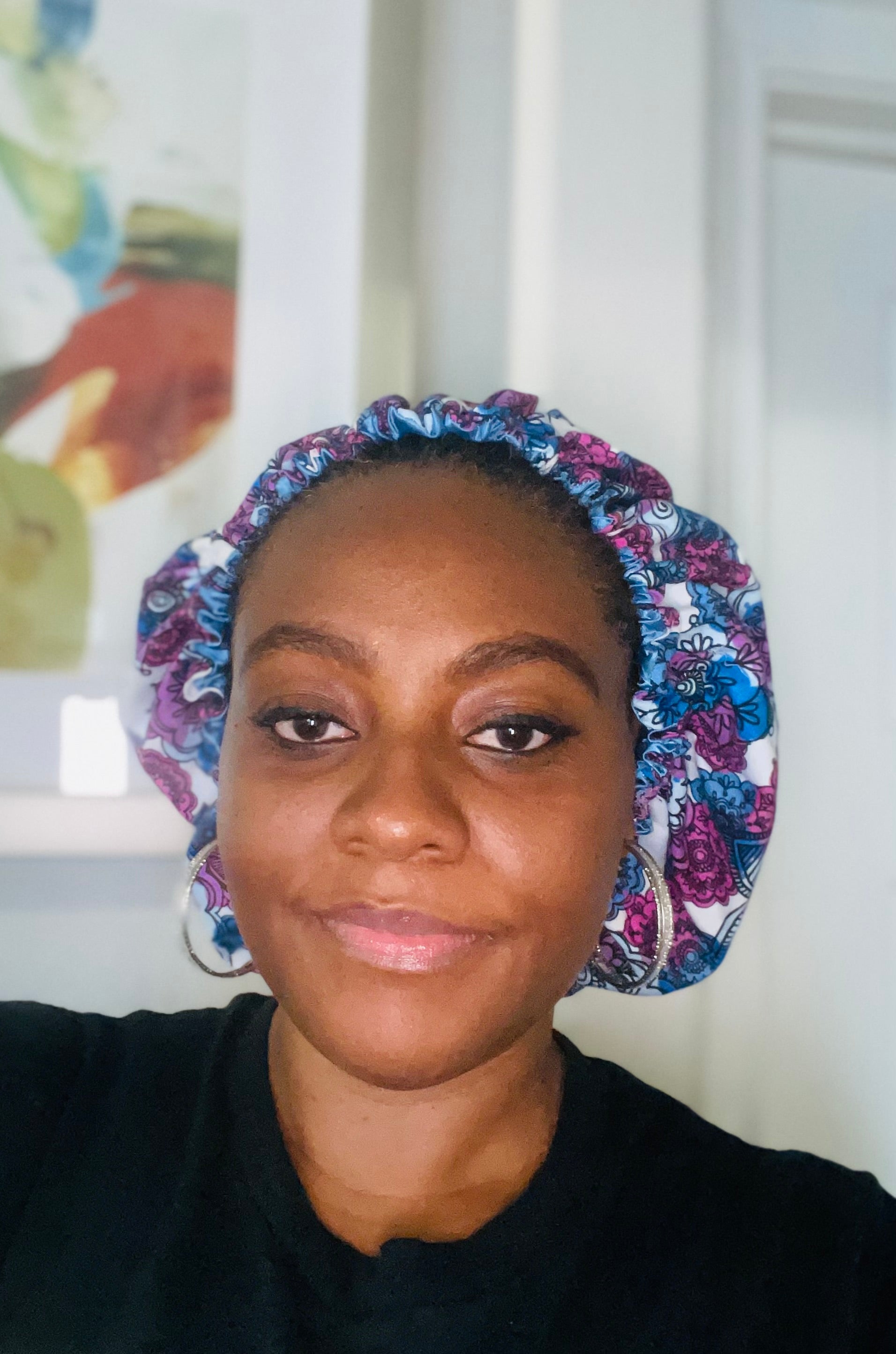 Person wearing a colorful floral headscarf indoors